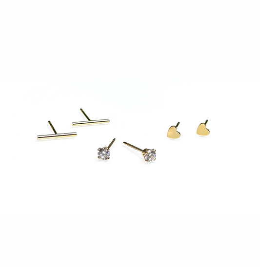 Three pairs of stud earrings, featuring minimalistic designs including bar, cubic zirconia accents, and heart shapes, all crafted from 14K gold-filled material.