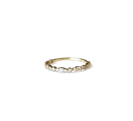 Gold ring with small cubic zirconia on a white background