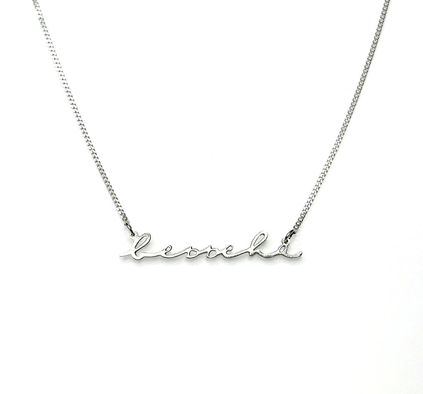 Close up of dainty minimalist name necklace in 14K gold-filled showing personalised script - shower safe everyday jewellery