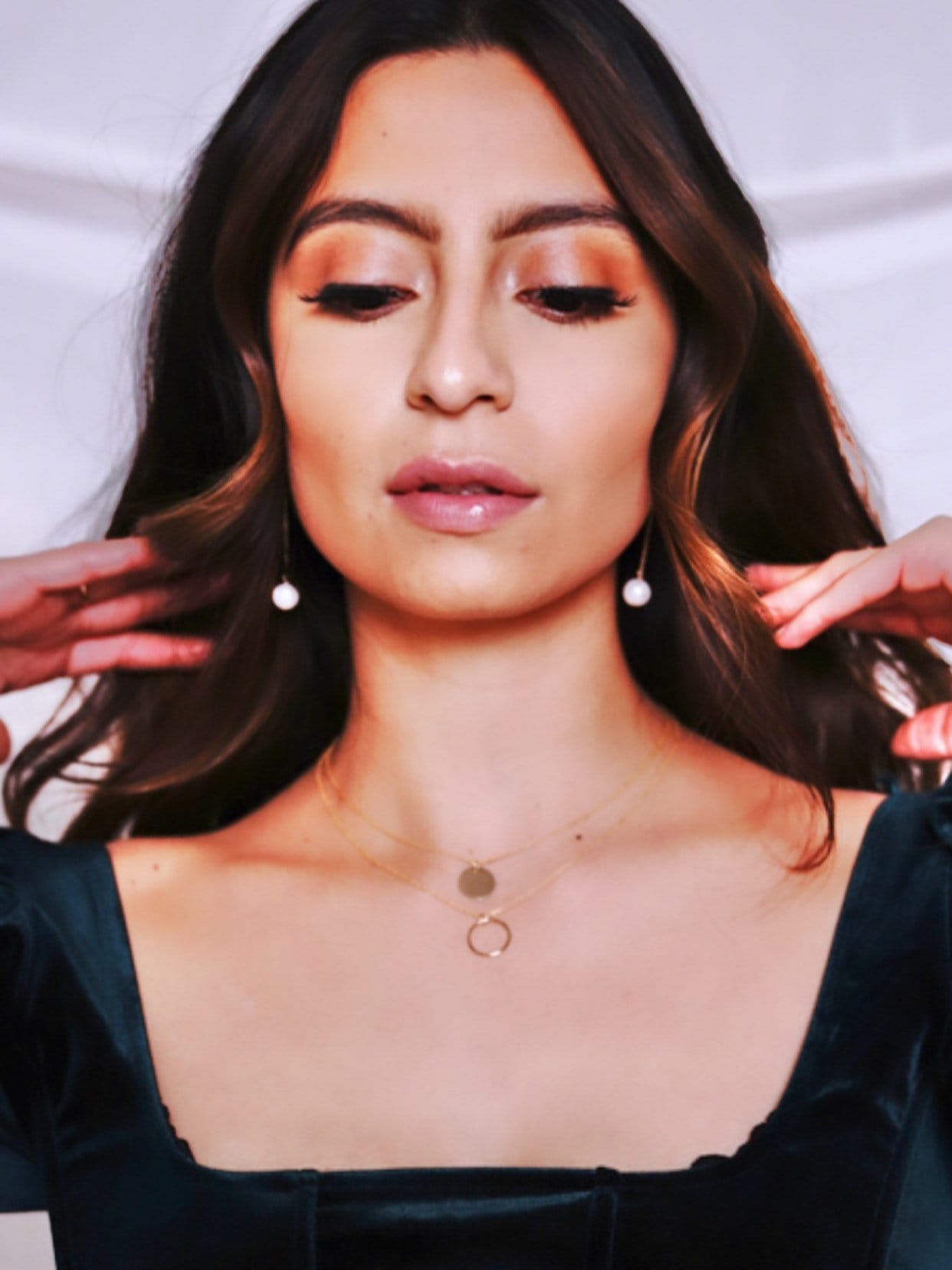 Dangly pearl earrings styled and worn showing 1.5 inch length, perfect for everyday elegance