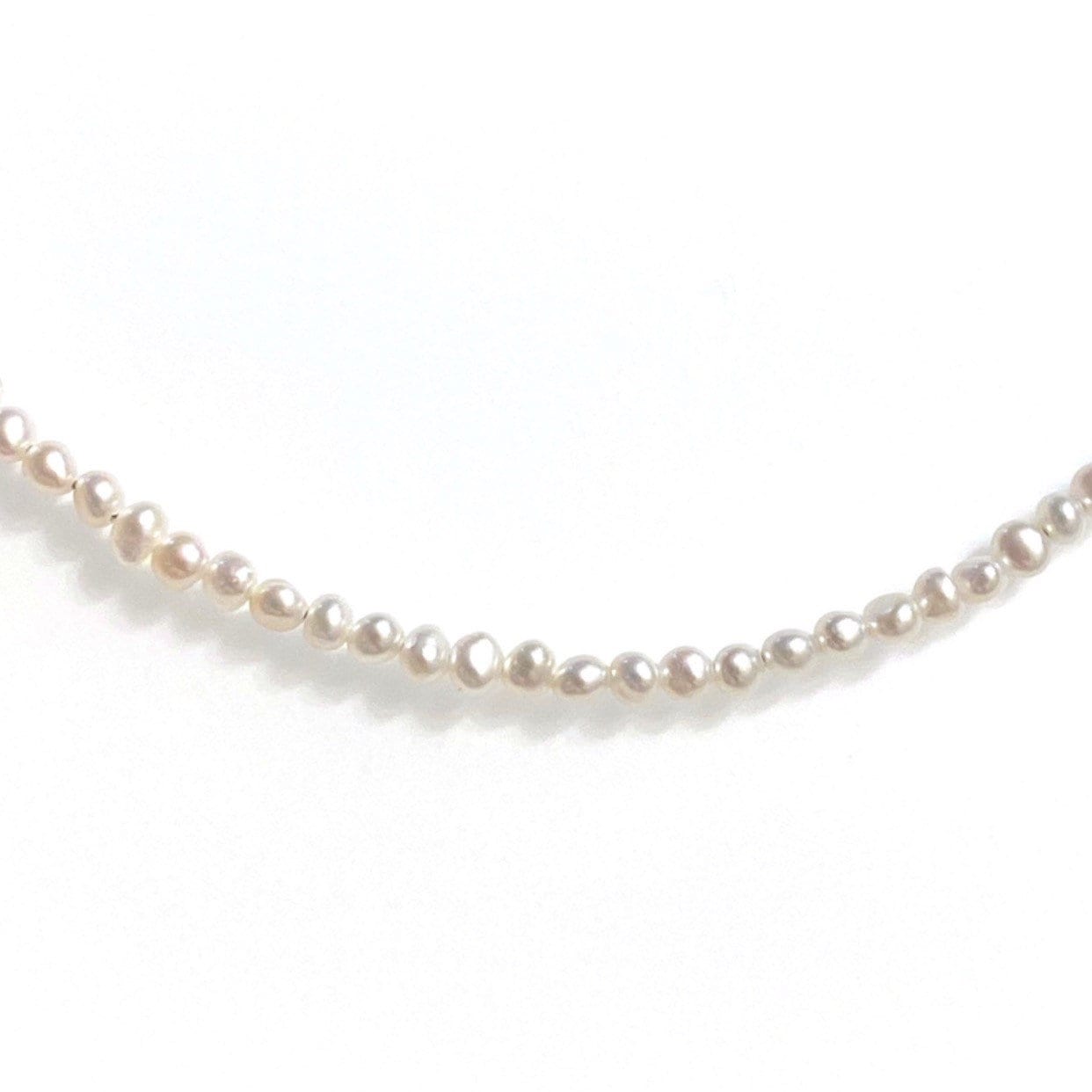 Baby freshwater pearl necklace styled and worn as choker showing versatile length options