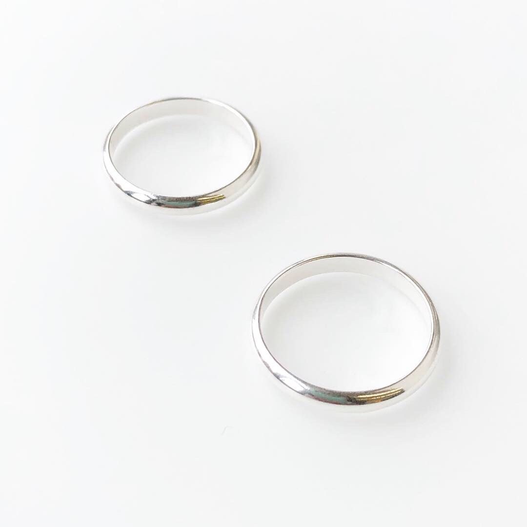 Close-up detail of sterling silver band ring showing 925 sterling silver quality