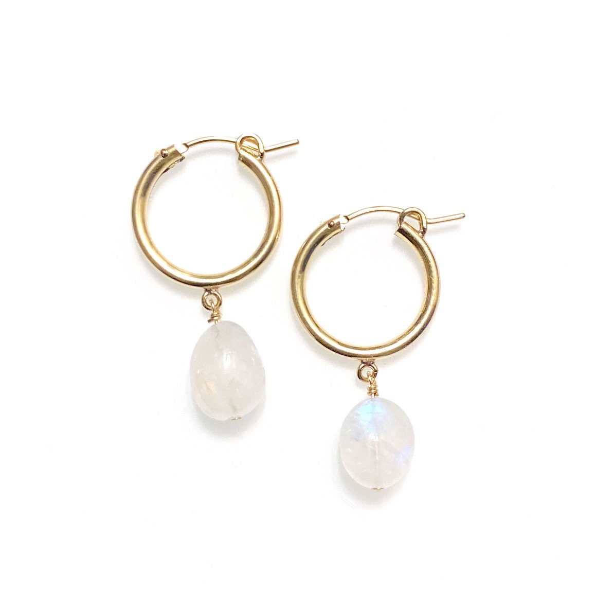 A pair of gold-filled hoop earrings with rainbow moonstone gemstone drops, displayed against a white background.