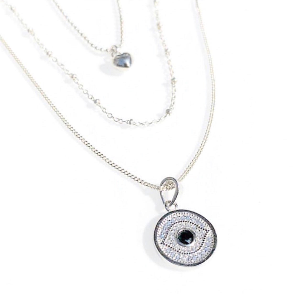 sterling silver evil eye medallion layered with satellite and petite puffy heart necklace