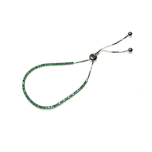 A green cubic zirconia bolo tennis bracelet with sterling silver accents on a white background.