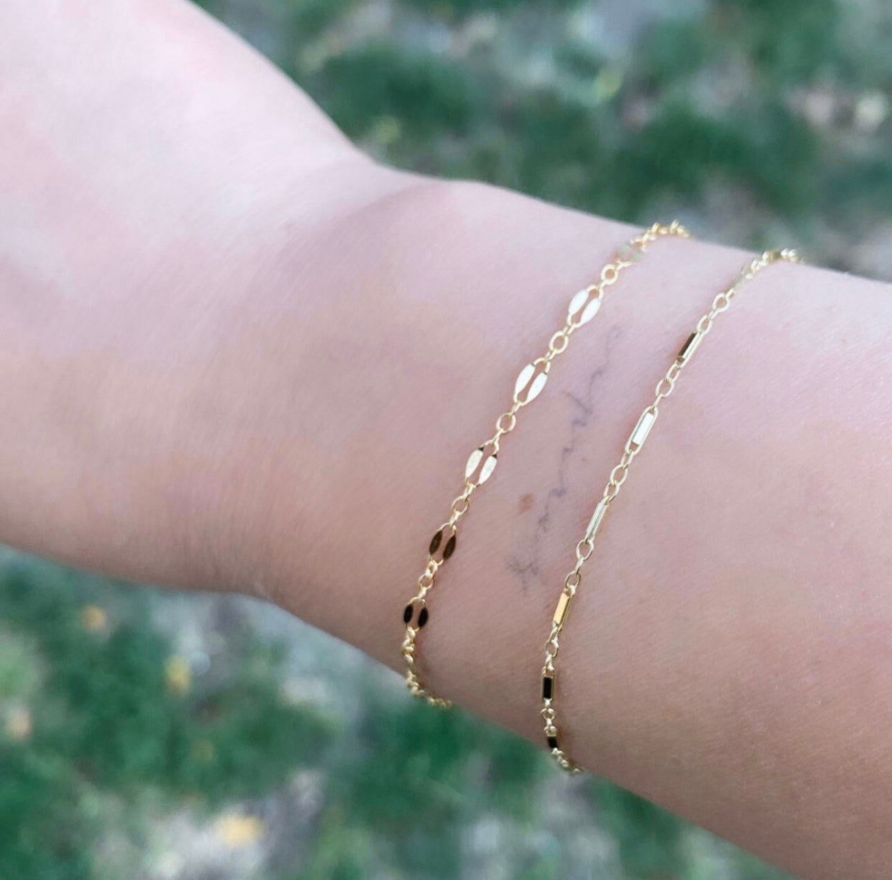 Close-up of dainty twin chain and gold bar chain showing 14K gold-filled detail