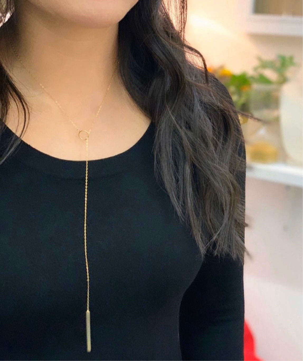 Signature lariat necklace styled and worn showing versatile bar and circle closure