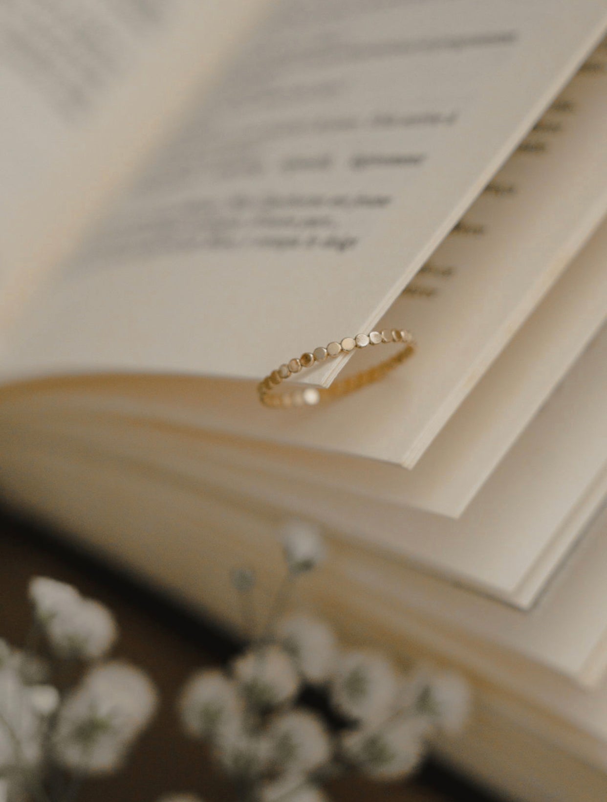 Side profile of 10K gold coin eternity band showing texture and detail