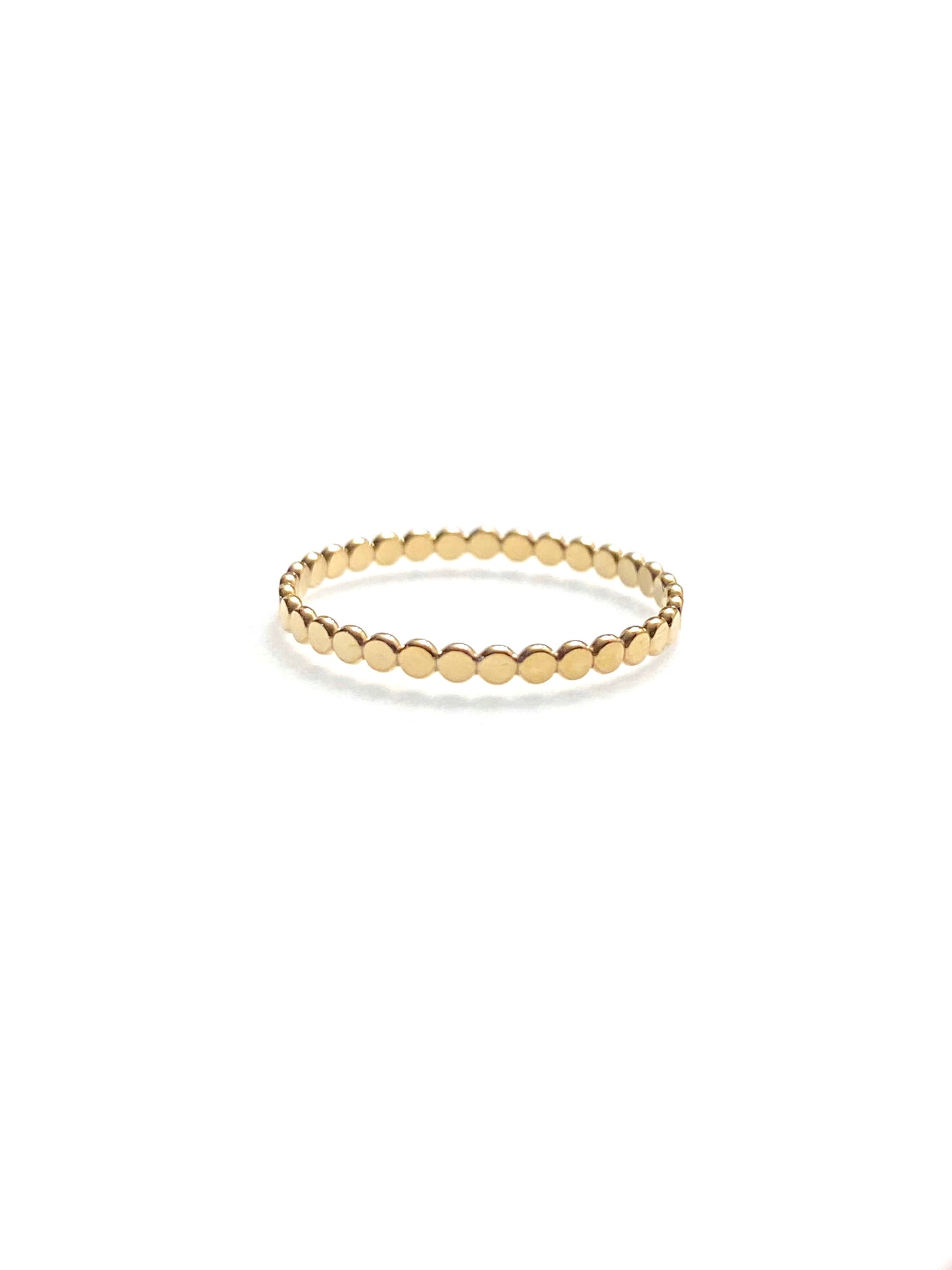 10K gold coin eternity ring styled and stacked with other rings