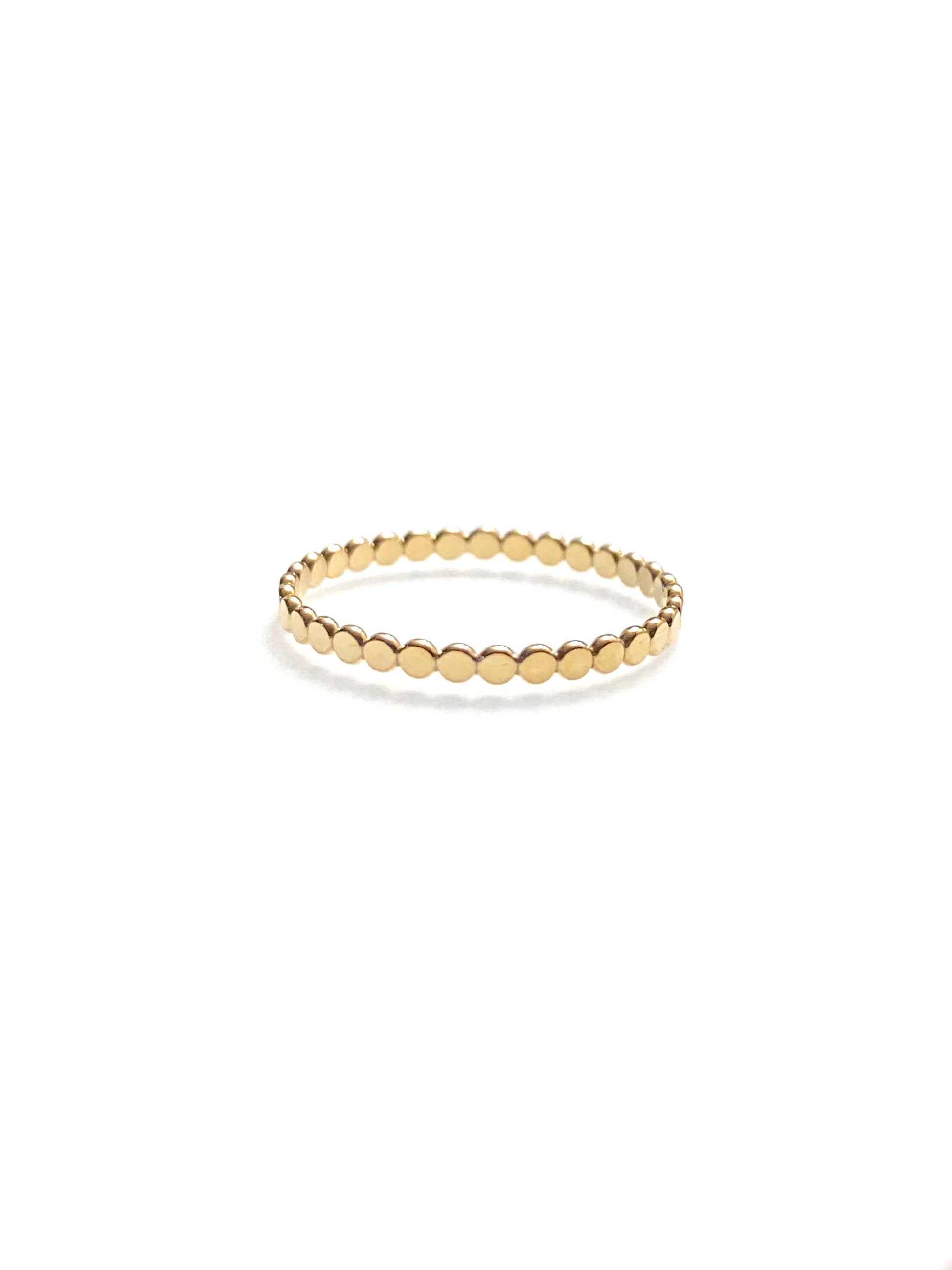 10K gold coin eternity ring styled and stacked with other rings