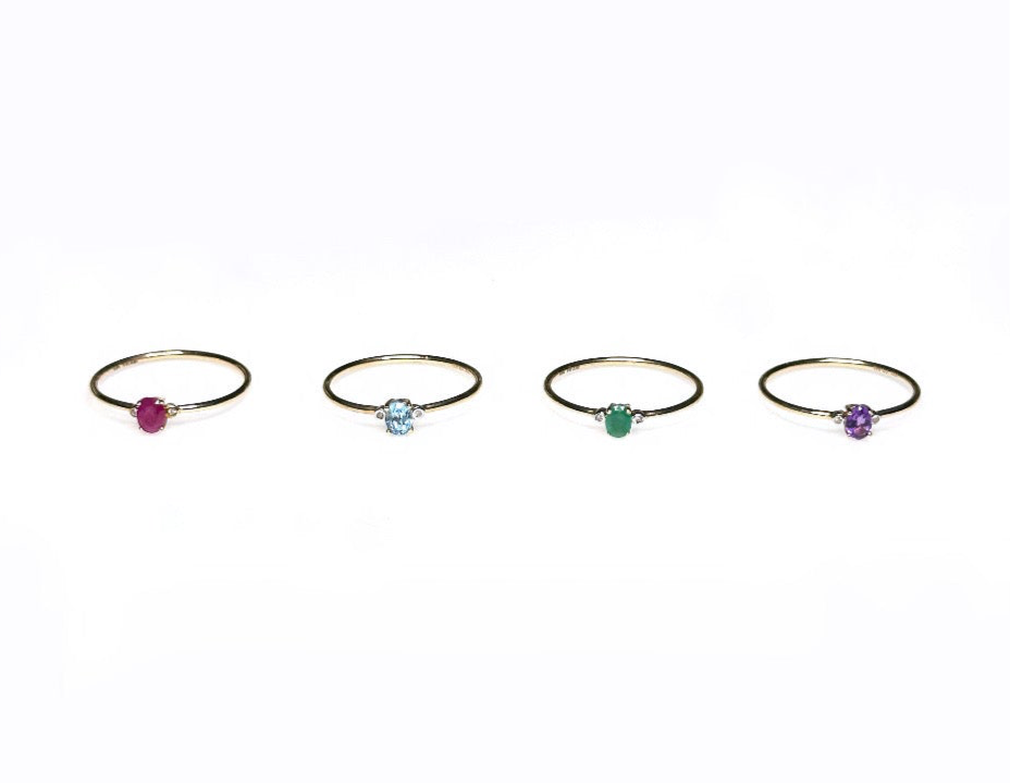 Gold gemstone rings showing ruby, emerald, topaz, and amethyst options.