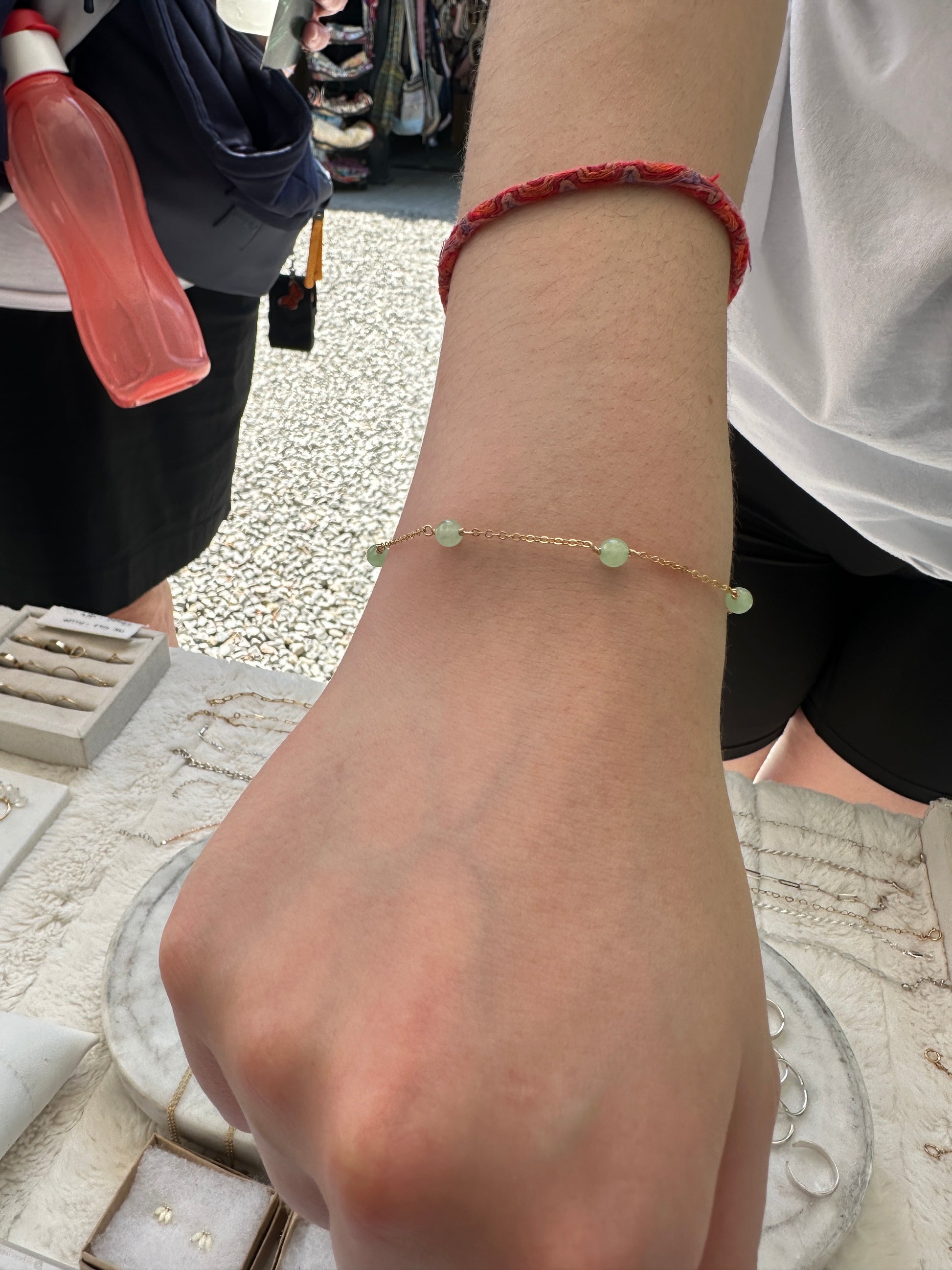 Staccato gemstone bracelet lifestyle shot in 14K gold-filled with serpentine, sapphire, and malachite - shower safe jewellery
