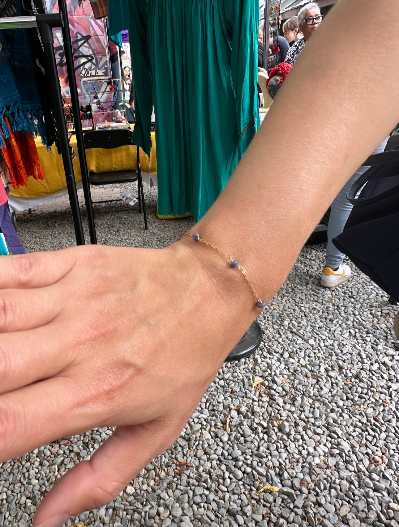 Close up of Staccato gemstone bracelet and necklace in 14K gold-filled featuring serpentine, sapphire, and malachite beads

