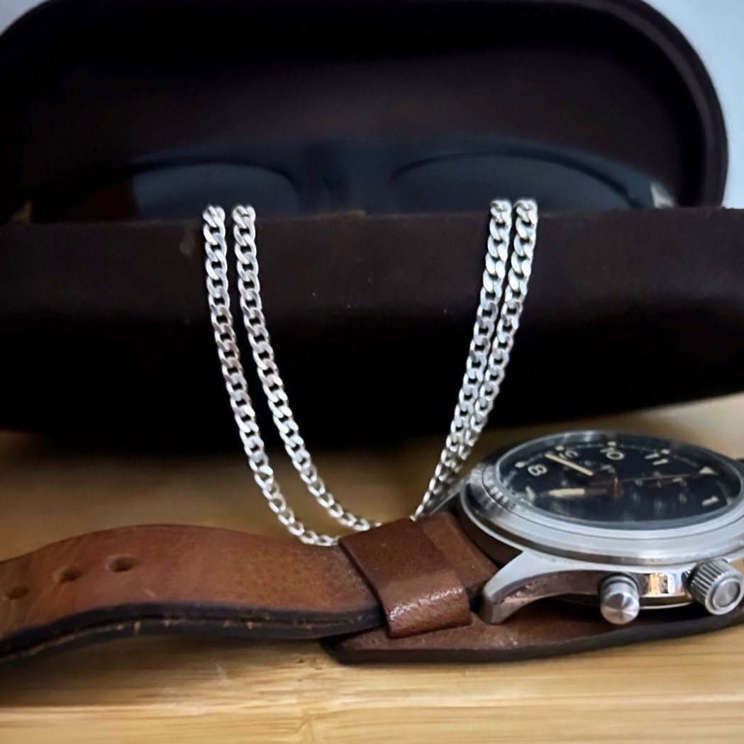 3mm sterling silver curb chain shown with sunglass case and watch