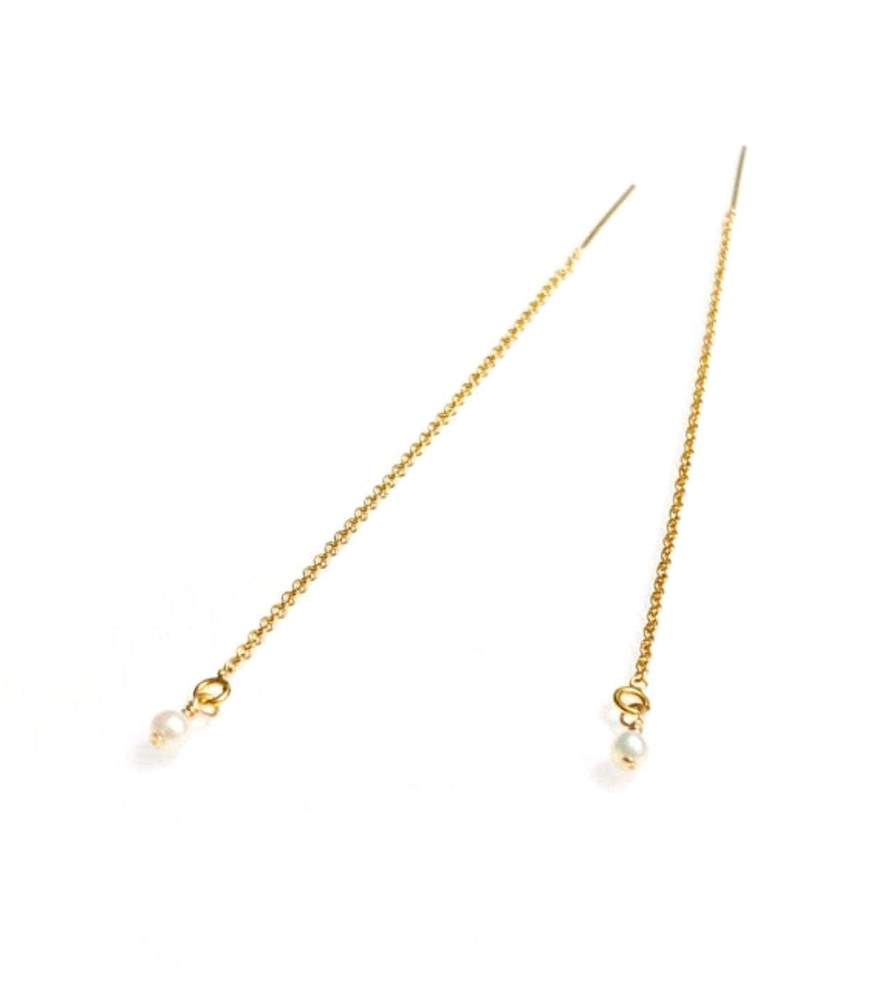 A pair of 14K gold-filled threader earrings with freshwater pearls at the ends, displayed against a white background.