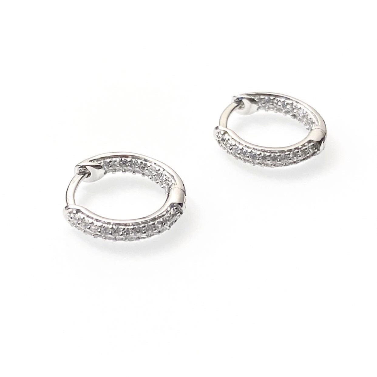 Endless sparkle CZ huggie earrings in sterling silver with cubic zirconia stones, available in 14mm and 20mm sizes
