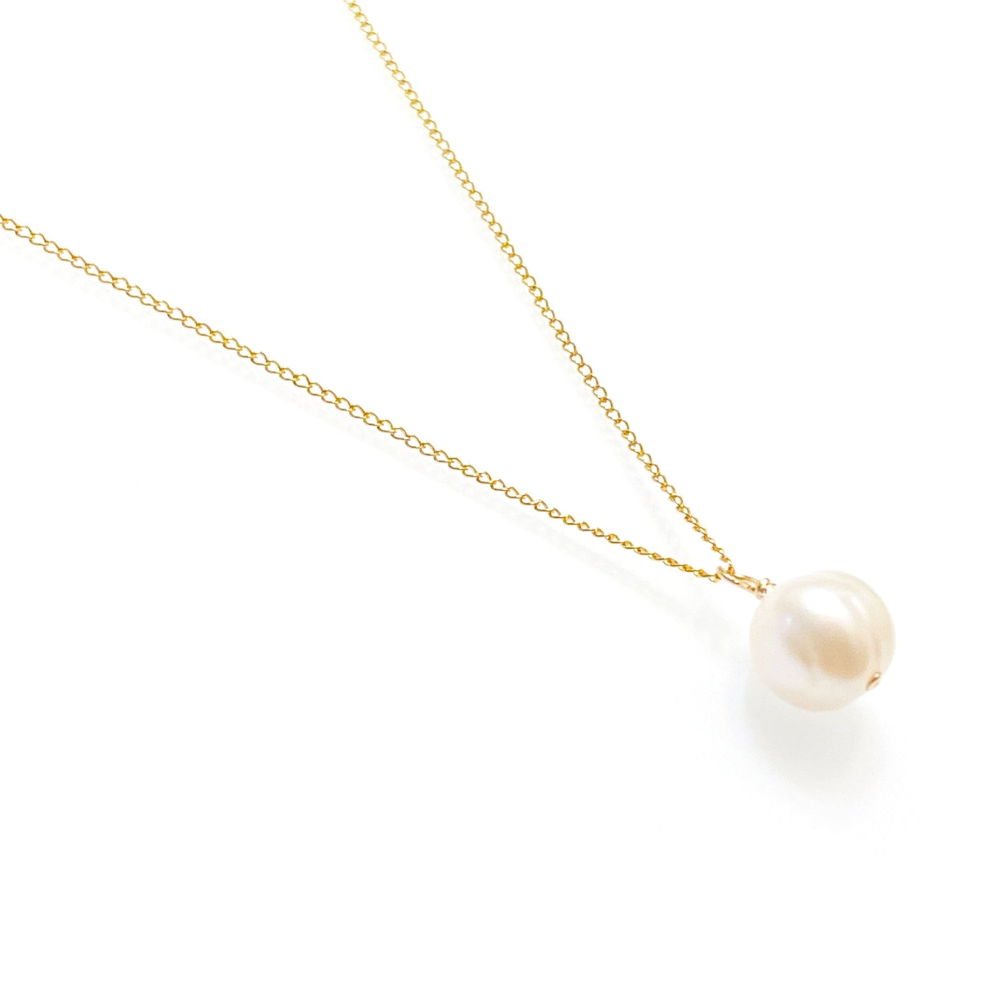 Minimalist pearl necklace showing 14K gold-filled and sterling silver chain options