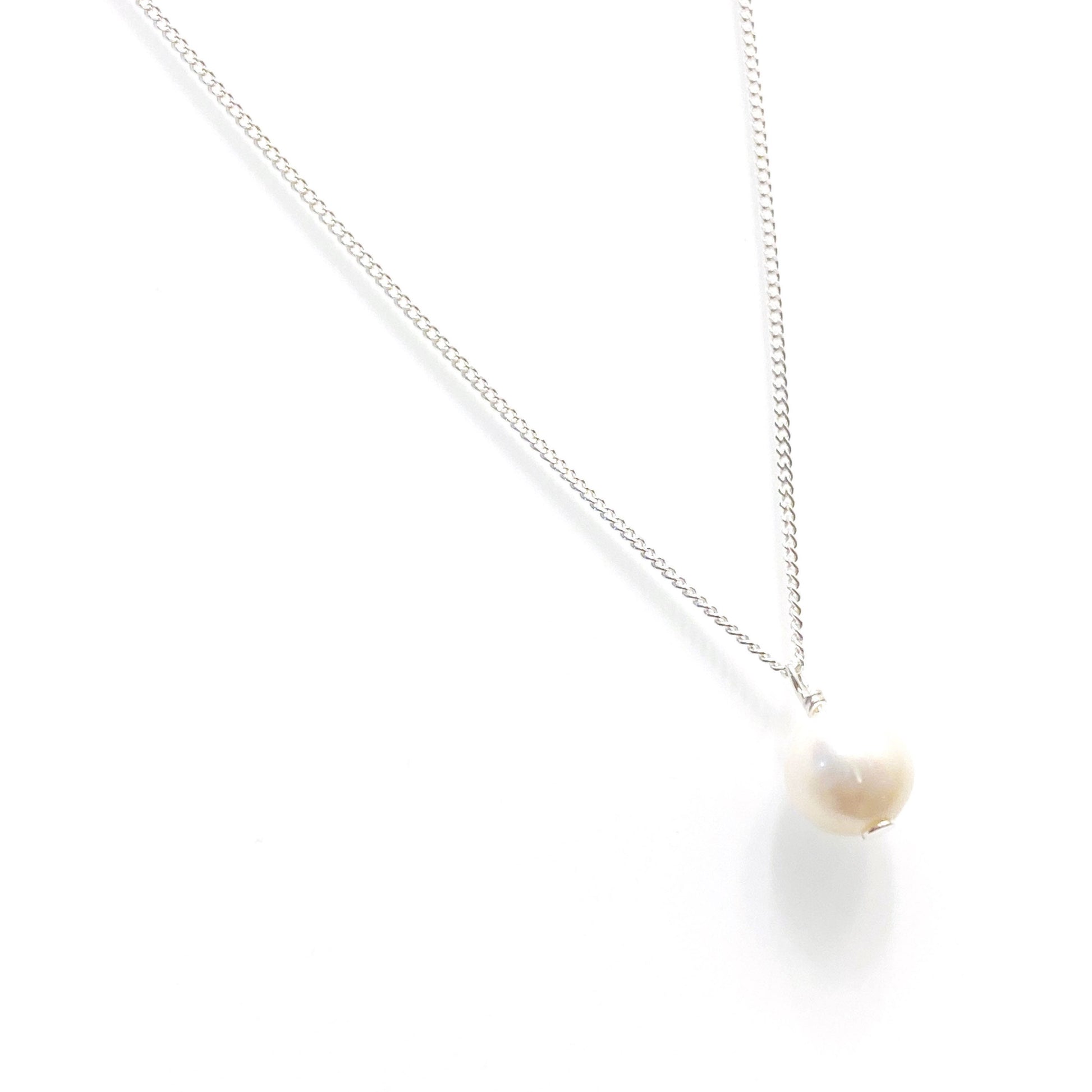 Minimalist freshwater pearl necklace styled and worn, perfect for bridal or everyday elegance