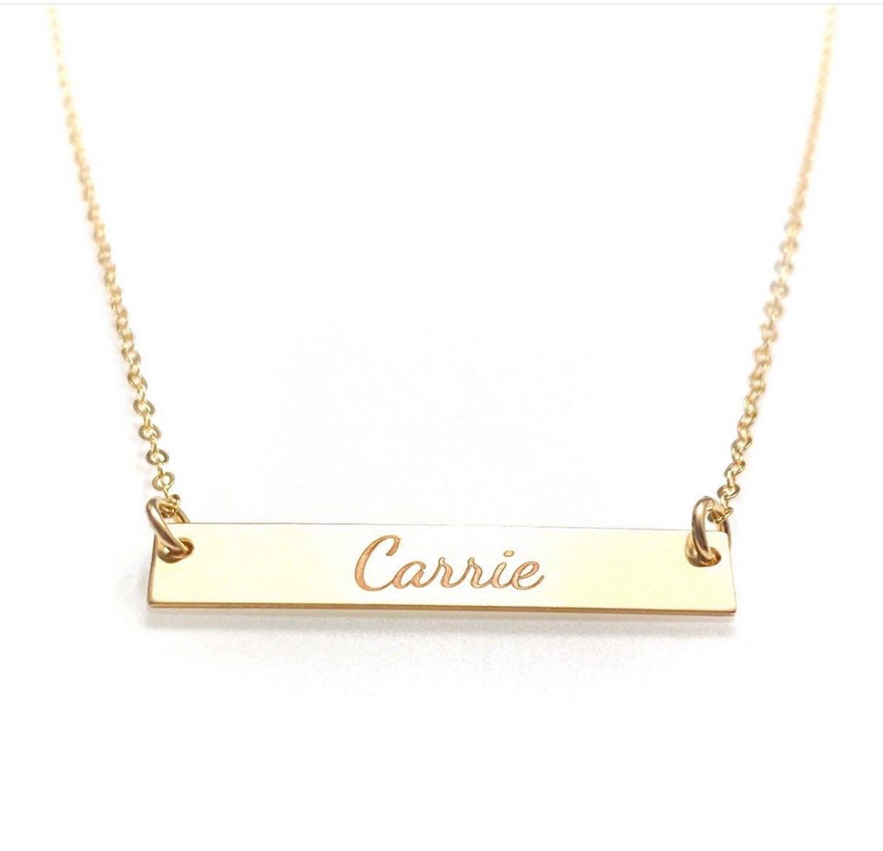 name plate necklace engraved with the name "Carrie"