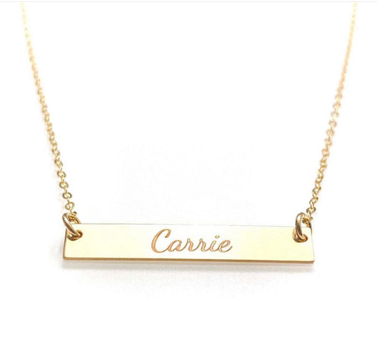 name plate necklace engraved with the name "Carrie"