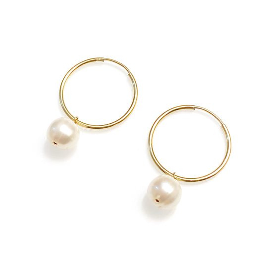 gold filled minimalist pearl earrings against white background