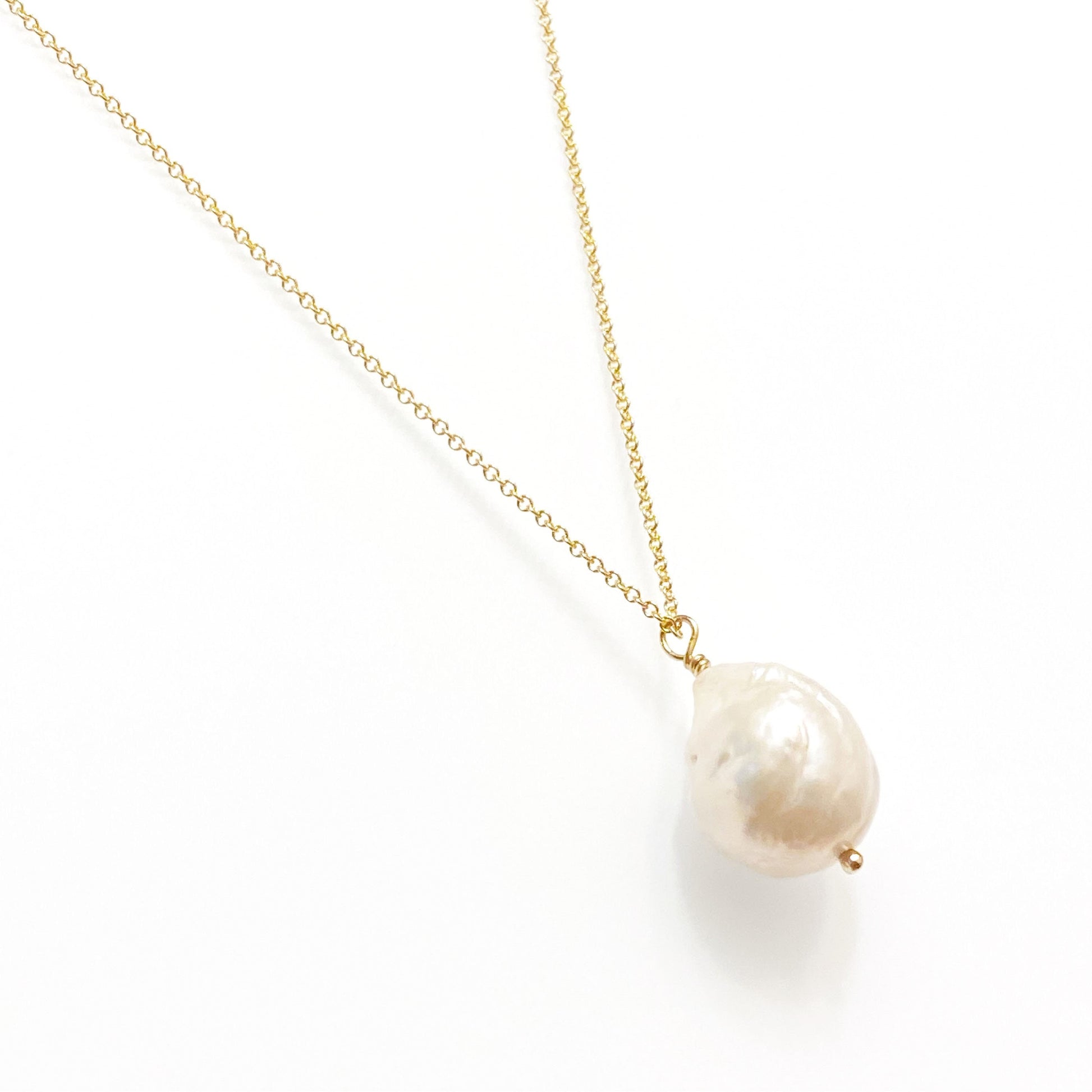 A single freshwater pearl necklace on a gold-filled chain, displayed against a white background.