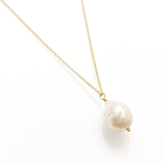 A single freshwater pearl necklace on a gold-filled chain, displayed against a white background.
