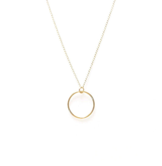 A minimalist gold-colored necklace featuring a perfect circle pendant, displayed on a white background.