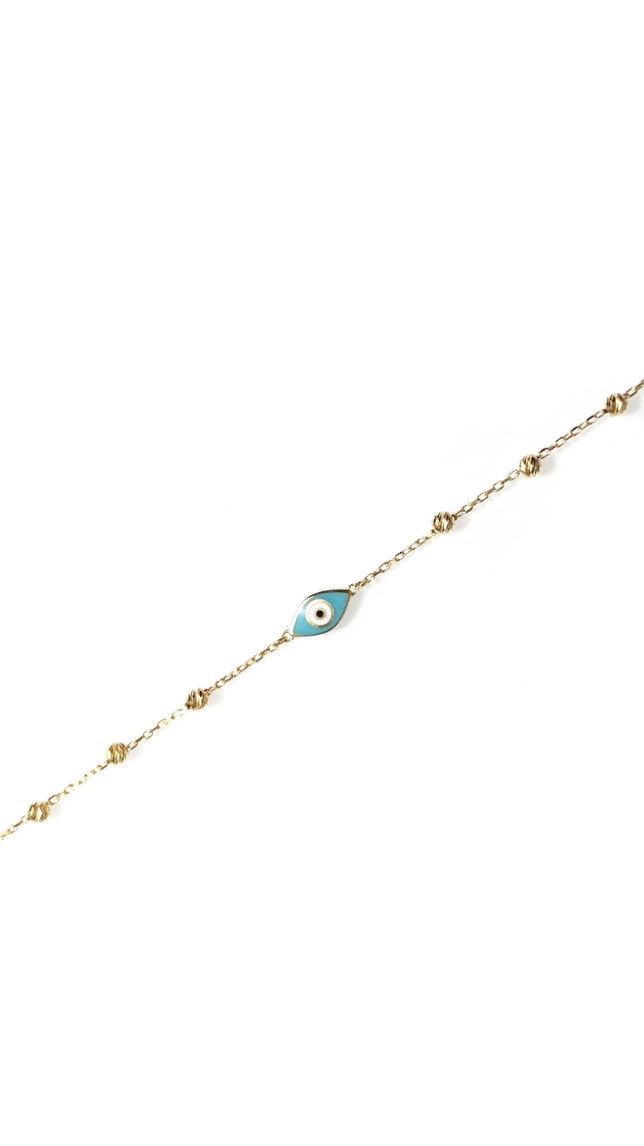 sparkly evil eye bracelet in solid gold against white background