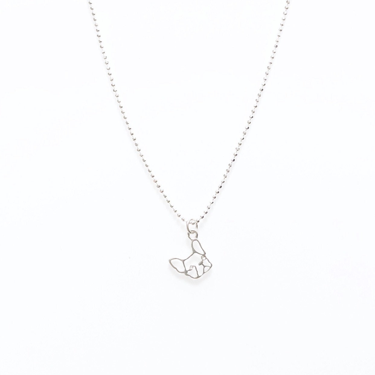 A sterling silver Frenchie bulldog pendant necklace on a ball chain.