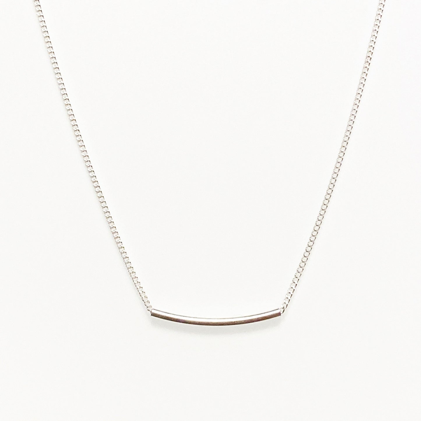 sterling silver line necklace against white background