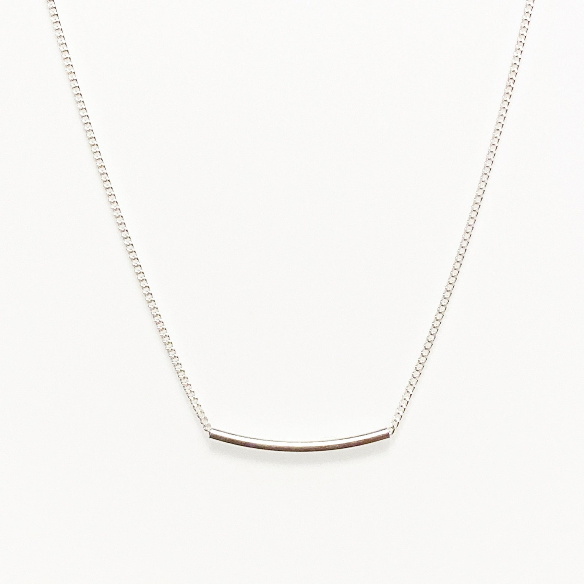 sterling silver line necklace against white background