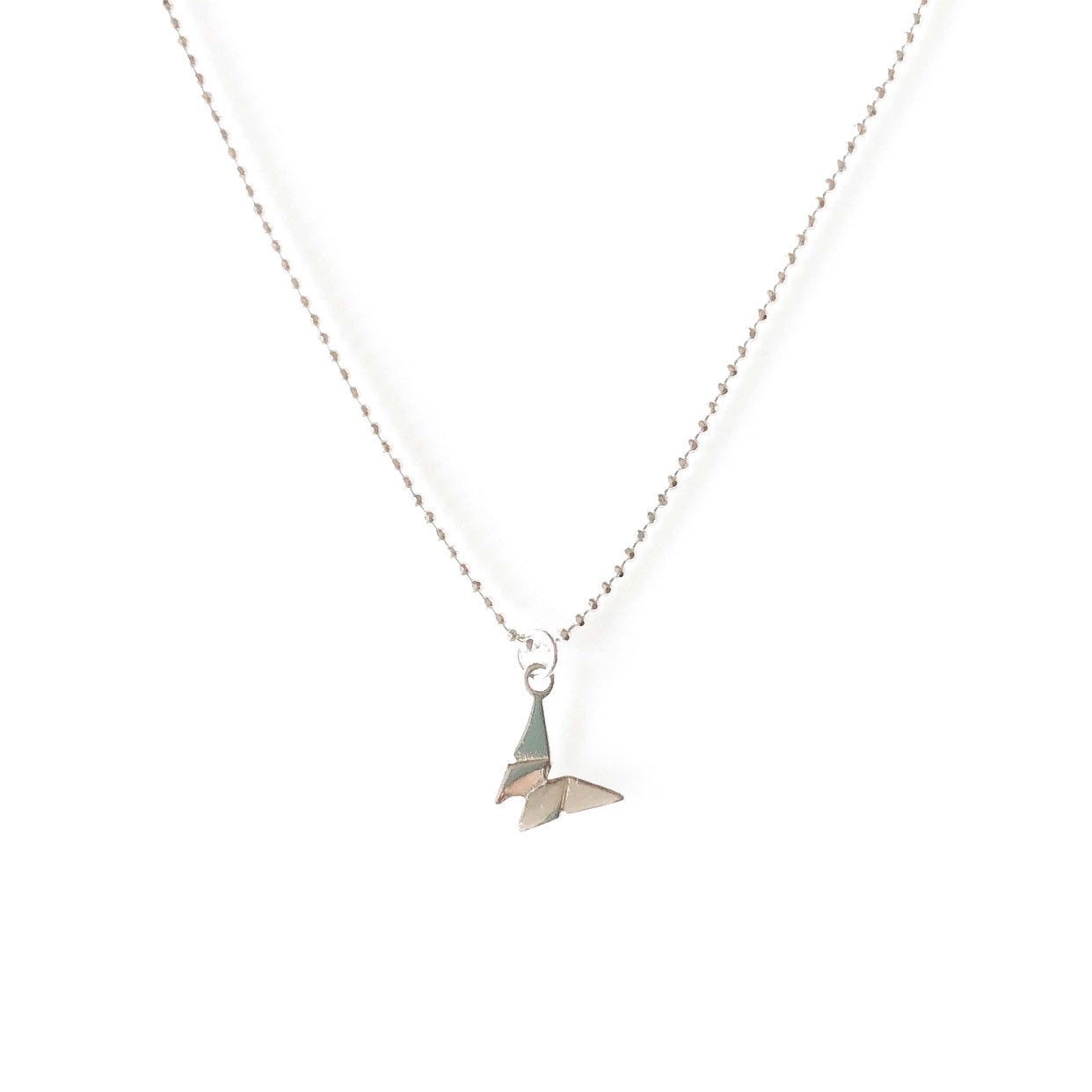 A sterling silver origami butterfly necklace on a faceted ball chain.